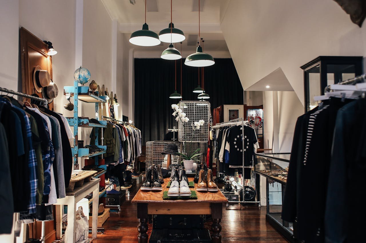 Chic clothing boutique with stylish clothing racks and accessories on display.